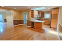 Open concept living area boasts hardwood floors, a wine cooler, and a seamless flow to the kitchen at 3004 Bay Shore Cir, Sarasota, FL 34234