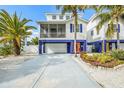 Charming two-story stilt home featuring a two-car garage and a welcoming screened porch at 316 64Th St, Holmes Beach, FL 34217