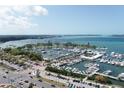 Aerial view of a busy marina with docks filled with sailboats and yachts at 33 S Gulfstream Ave # 905, Sarasota, FL 34236