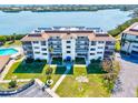 Well-maintained complex with lush landscaping, a pool, and ample parking for residents and guests at 3540 Gulf Of Mexico Drive # 202, Longboat Key, FL 34228