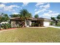 Well-maintained front yard with lush landscaping complements this charming single-story home at 3736 Fontainebleau St, North Port, FL 34287