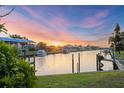 Picturesque waterfront view showcasing a canal, private boat docks, and beautiful sunset at 4405 Harbor Blvd, Port Charlotte, FL 33952