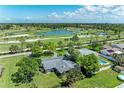 Aerial view of a home next to a golf course with a large pond and green landscape at 4611 17Th W Ave, Bradenton, FL 34209