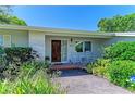 Inviting front entrance with a decorative wood door and a cozy seating area at 4611 17Th W Ave, Bradenton, FL 34209