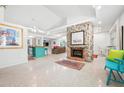 Bright and spacious living area with a stone fireplace, open floor plan, and ample lighting at 528 45Th St, Sarasota, FL 34234