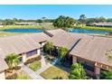 Aerial view featuring the community, a tranquil lake, and a well-maintained condo at 6209 Heritage Ln # 6209, Bradenton, FL 34209