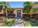 Inviting home showcasing a walkway and lush landscaping with vibrant plants and mature trees at 6209 Heritage Ln # 6209, Bradenton, FL 34209