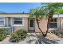 Welcoming front entrance with a well-kept garden, featuring palm trees adding a touch of tropical charm at 6240 7Th W Ave # 6240, Bradenton, FL 34209