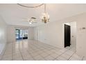 Spacious living room with neutral tile flooring, a ceiling fan, and ample natural light, ready for personalization at 6240 7Th W Ave # 6240, Bradenton, FL 34209