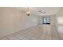 Bright living room featuring tile flooring and a sliding door, offering a seamless transition to outdoor living at 6240 7Th W Ave # 6240, Bradenton, FL 34209