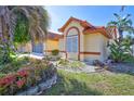 Attractive single-story home featuring a well-manicured lawn and colorful tropical landscaping at 6415 39Th W Ave, Bradenton, FL 34209