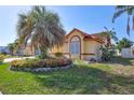 Beautiful home featuring manicured landscaping, a mature palm tree, and great curb appeal at 6415 39Th W Ave, Bradenton, FL 34209