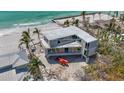 Modern home with a flat roof overlooking the ocean, showcasing its contemporary architectural design at 6603 Gulfside Rd, Longboat Key, FL 34228