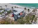 Aerial shot of a contemporary home featuring a flat roof, and situated in a beachfront community at 6603 Gulfside Rd, Longboat Key, FL 34228