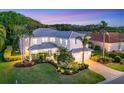 Beautiful home showcasing lush landscaping, a well-manicured lawn, and a brick driveway at 7538 Camden Harbour Dr, Bradenton, FL 34212