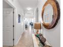 Neutral interior hallway with decor and view into the living room at 7803 Grand Estuary Trl # 102, Bradenton, FL 34212