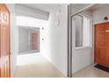 Bright hallway showing doors and exterior-facing window of condo unit at 7803 Grand Estuary Trl # 102, Bradenton, FL 34212