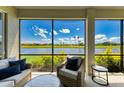 Relaxing screened-in lanai with comfortable seating and a beautiful lake view at 8304 Grand Estuary Trl # 104, Bradenton, FL 34212