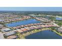 Beautiful aerial view of a community of single Gathering homes surrounding several ponds and lakes in a golf community at 7036 Highgate Ln, Lakewood Ranch, FL 34202