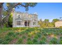 Beautiful brick home showcasing detailed architecture and lush landscaping, creating a picturesque setting at 1577 Alexander Rd, Belleair, FL 33756