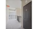 Hallway with an exit sign and an exterior view from the walkway at 17902 Gawthrop Dr # 401, Bradenton, FL 34211