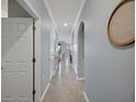 Inviting hallway featuring tile flooring, archway, and soothing blue walls at 17902 Gawthrop Dr # 401, Bradenton, FL 34211