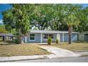 Attractive single-story house displays a lush front yard with mature trees providing ample shade and curb appeal at 1823 8Th E Ave, Bradenton, FL 34208