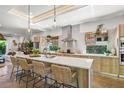 Bright kitchen with an island, quartz countertops, stainless steel appliances, and designer accents at 2124 Wisteria St, Sarasota, FL 34239