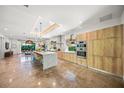 Modern kitchen featuring an island with counter seating, stainless appliances, and an open floor plan at 2124 Wisteria St, Sarasota, FL 34239