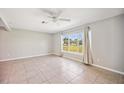Bright living room with tile floors, neutral walls, and a large window view at 219 Marlin Dr, Punta Gorda, FL 33950