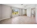 Bright living room with tile floors, neutral walls, and large window at 219 Marlin Dr, Punta Gorda, FL 33950