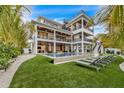 Luxury home showcasing a modern swimming pool, spacious lawn, and comfortable lounge chairs at 224 Chilson Ave, Anna Maria, FL 34216