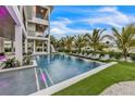 Stunning infinity pool view with lush landscaping and elegant lounge seating, offering a serene oasis at 224 Chilson Ave, Anna Maria, FL 34216