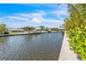 Beautiful waterfront homes line a peaceful canal with boat docks on a sunny day at 224 Chilson Ave, Anna Maria, FL 34216