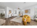 Bright living room with wood floors, a plush rug, comfortable furniture, and natural light at 25364 Tether Ln, Punta Gorda, FL 33983