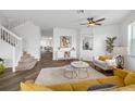 Inviting living room with modern decor, wood floors, and staircase access at 25364 Tether Ln, Punta Gorda, FL 33983