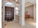 Spacious foyer with tile floors and an arched window offers a glimpse into the dining area at 3738 Eagle Hammock Dr, Sarasota, FL 34240