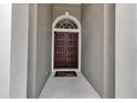 Elegant home entrance featuring a double door and transom window at 3738 Eagle Hammock Dr, Sarasota, FL 34240