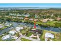 Aerial shot showcasing the waterfront property with lush landscaping, pool, canal access and circular driveway at 4355 Pompano Ln, Palmetto, FL 34221