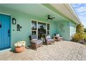 Charming covered front porch features comfortable seating, stylish decor, and a welcoming entrance at 4440 Yacht Club Dr, Venice, FL 34293