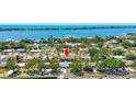 Expansive aerial view of a waterfront community with lush landscaping and tropical surroundings at 519 Bayview Ave, Osprey, FL 34229