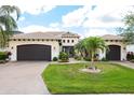 Elegant two-story home featuring a tile roof, manicured lawn, and a two-car garage at 5502 Tidewater Preserve Blvd, Bradenton, FL 34208