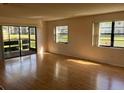 Sun-drenched living room featuring gleaming hardwood floors and large windows at 5970 80Th N St # 101, St Petersburg, FL 33709