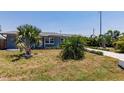 Well-maintained front yard with tropical landscaping enhancing the curb appeal at 6009 Lords Ave, Sarasota, FL 34231