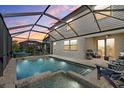 Enjoy outdoor living with this screened-in pool, spa, and covered patio area at 6535 Clairborne Ln, Bradenton, FL 34211