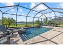 Screened in pool with a spa and comfortable seating overlooking a beautiful lake view at 6535 Clairborne Ln, Bradenton, FL 34211