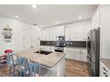 Bright kitchen features granite counters, stainless appliances, and an island with seating at 7322 34Th E Ct, Sarasota, FL 34243
