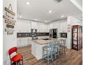 Bright kitchen features granite counters, stainless appliances, and an island with seating at 7322 34Th E Ct, Sarasota, FL 34243