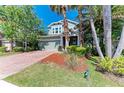 Charming two-story home with brick driveway, lush landscaping, and inviting curb appeal at 8243 Nandina Dr, Sarasota, FL 34240