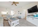 Cozy living room with a ceiling fan, light-colored walls, wood floors, and ample seating at 9630 Club South Cir # 6201, Sarasota, FL 34238